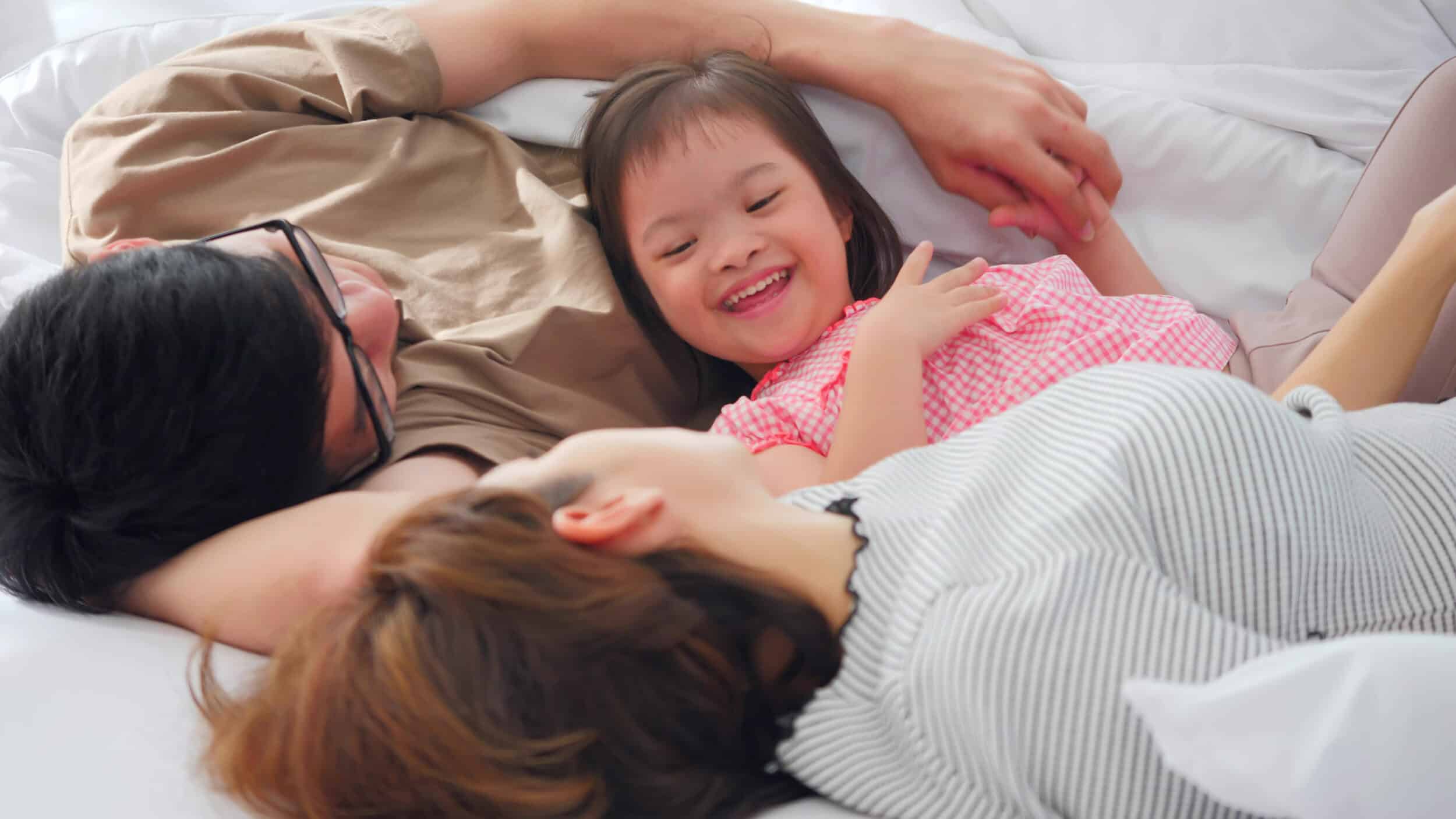 Happy family with mother, father and disabled daughter spending